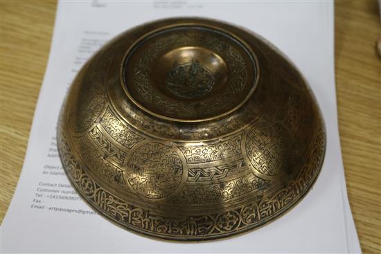 An Islamic bronze magic bowl with incised Koranic inscriptions within geometric motifs, Dia 7.5in (wear to interior)